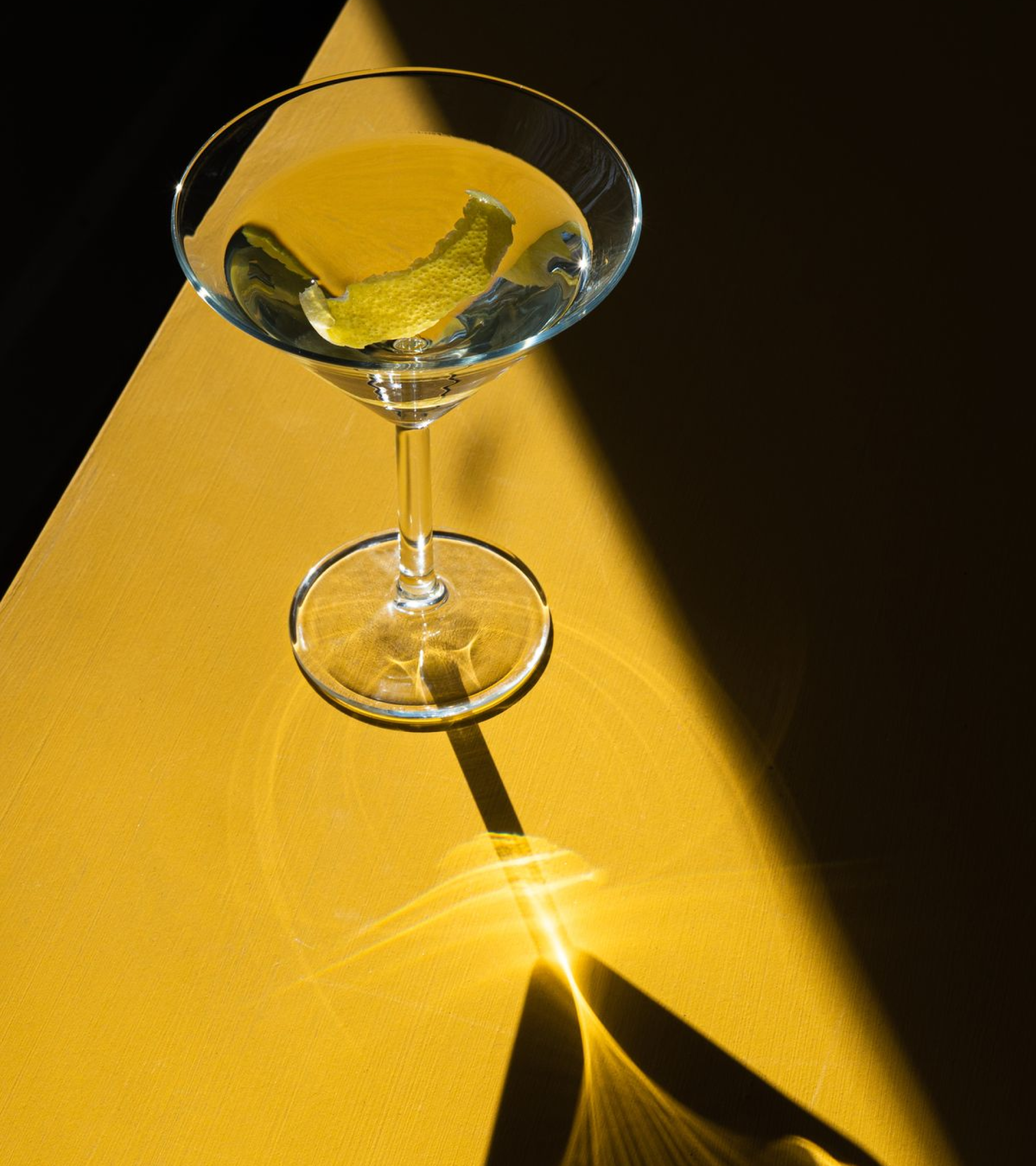 Stylized blue and pink image of a whiskey glass with the wordmark of Vèloce in pink all-caps letters above.